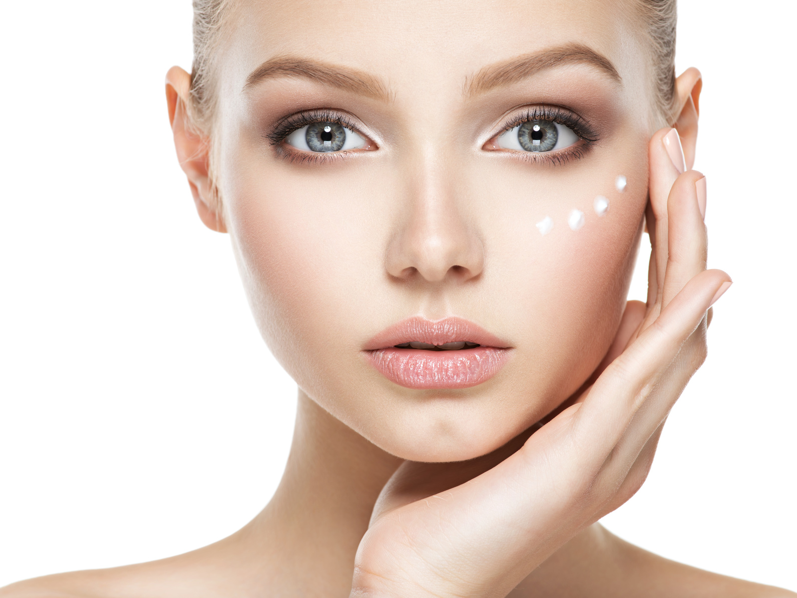 Young woman with cosmetic  cream on a clean fresh face